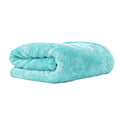 A folded turquoise blue microfiber towel with a soft, plush texture, shown on a clean white background with the brand name 'Lucullan' printed in black in the top left corner.