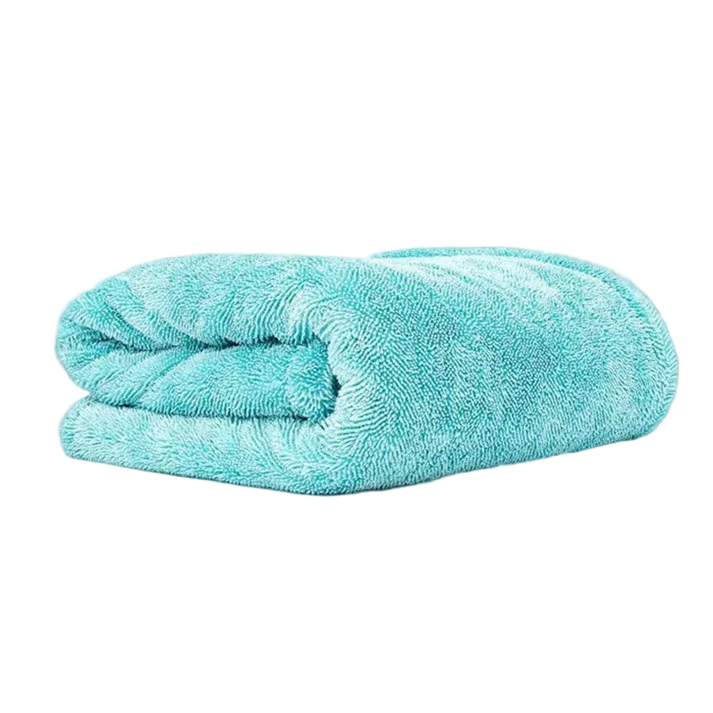 A folded turquoise blue microfiber towel with a soft, plush texture, shown on a clean white background with the brand name 'Lucullan' printed in black in the top left corner.